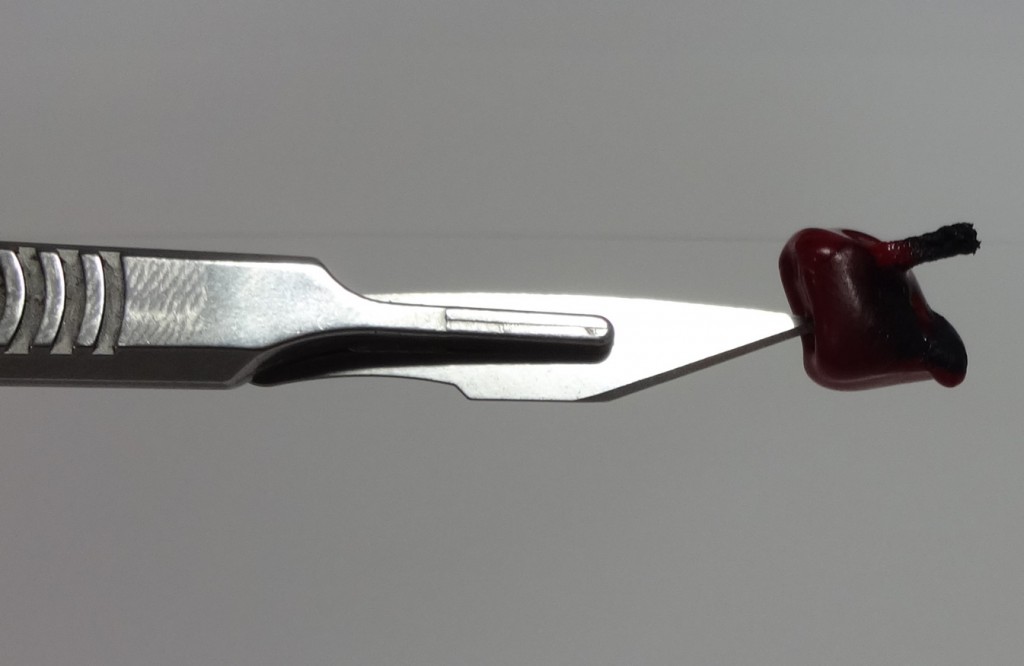 Sealing wax on the tip of a scalpel blade
